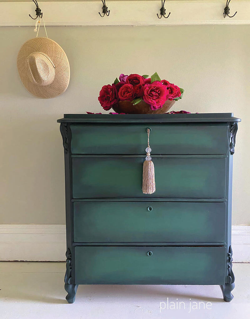 a green chest of drawers painted in plain jane chalk paint